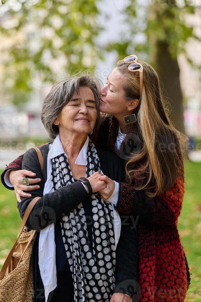 A Heartfelt Embrace. A Daughters Support for Her Mother on a Beautiful Autumn Day. photo