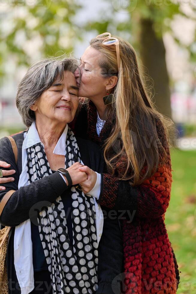 A Heartfelt Embrace. A Daughters Support for Her Mother on a Beautiful Autumn Day. photo