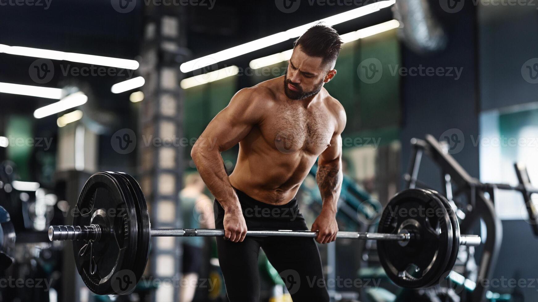 A man with a beard lifts a barbell during a workout in a modern gym. photo