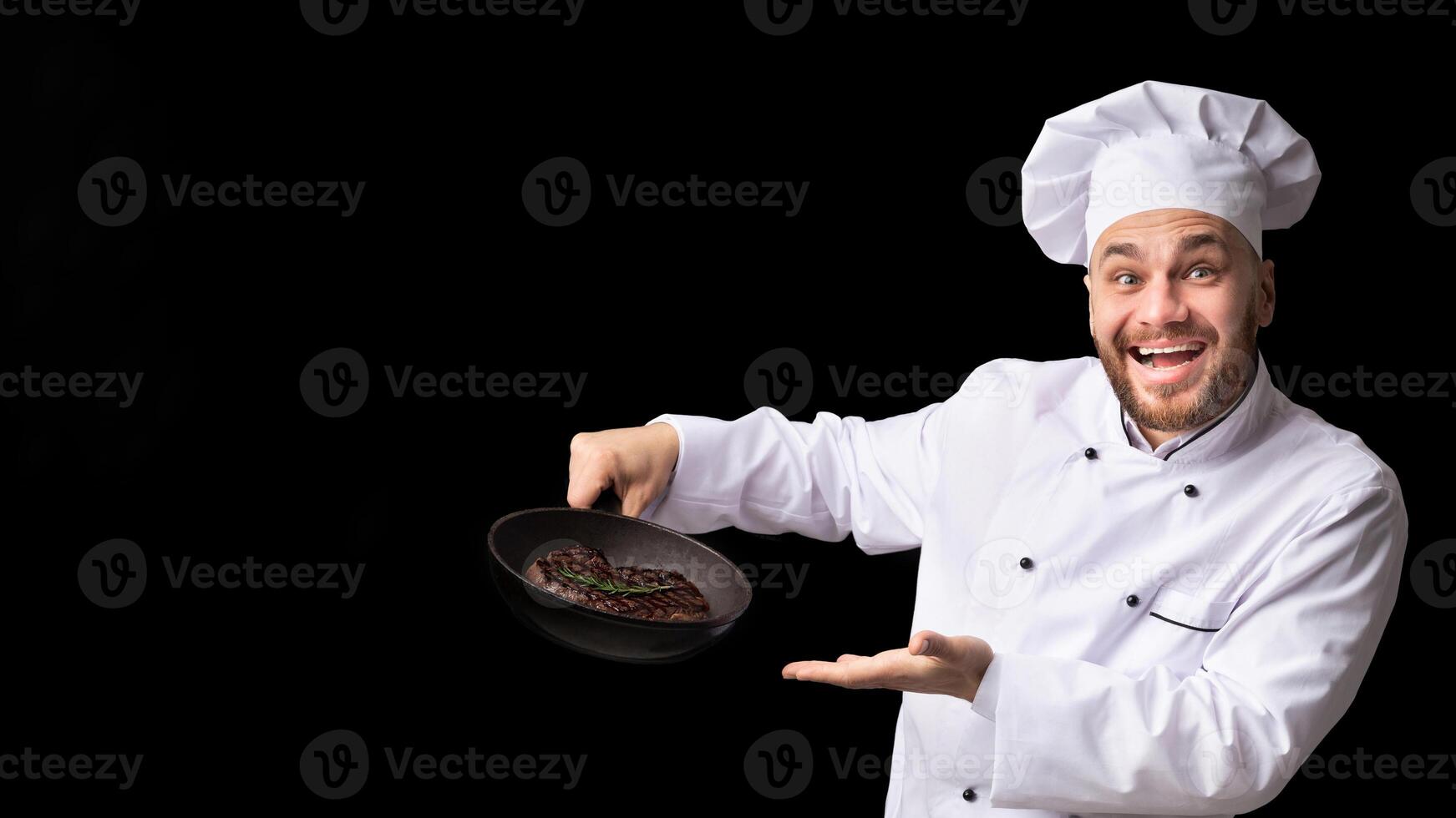 Cooking Meat. Professional Chef Man Holding Frying Pan With Fresh Steak Smiling To Camera Posing On Black Studio Background. Panorama photo