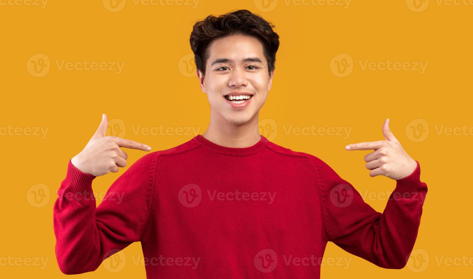 Choose An Pick Me. Self-assured and charismatic asian man pointing at self, wearing red sweater. Egocentric man promoting himself, indicating his body, isolated over orange studio background photo