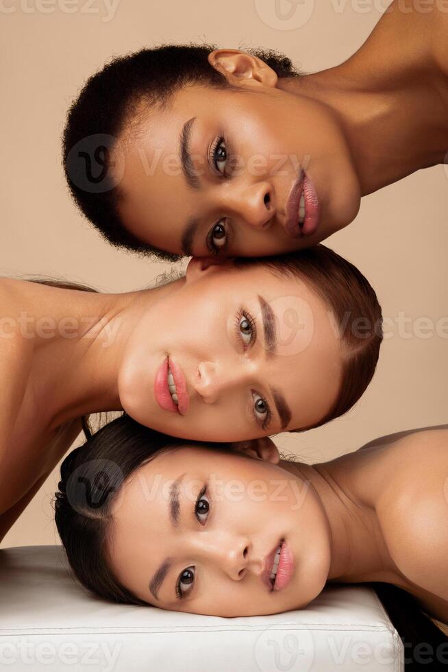 Portrait Of Three Diverse Women. African, Asian And Caucasian Girls Posing On Gray Background. Multi-Ethnic Female Beauty And Sensuality photo