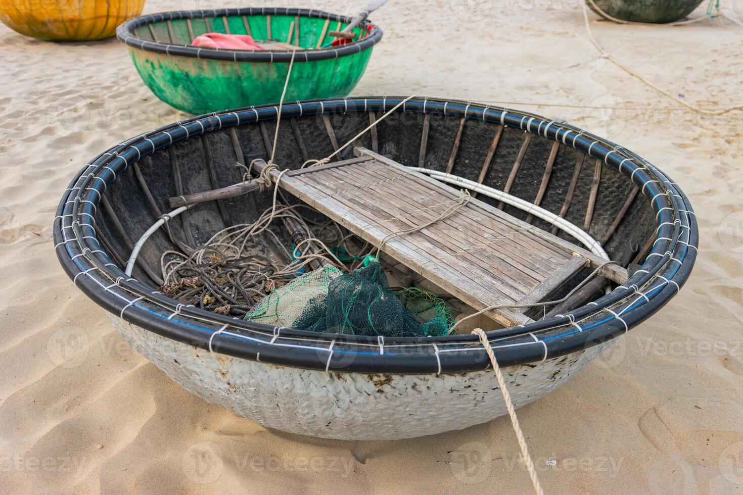 Round fishing boatsson the sand photo