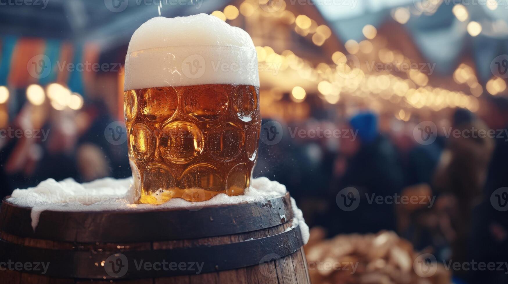 Frothy Beer in a Glass with a Wooden Barrel in the Foreground and a Blurred Crowd and Lights in the Background photo