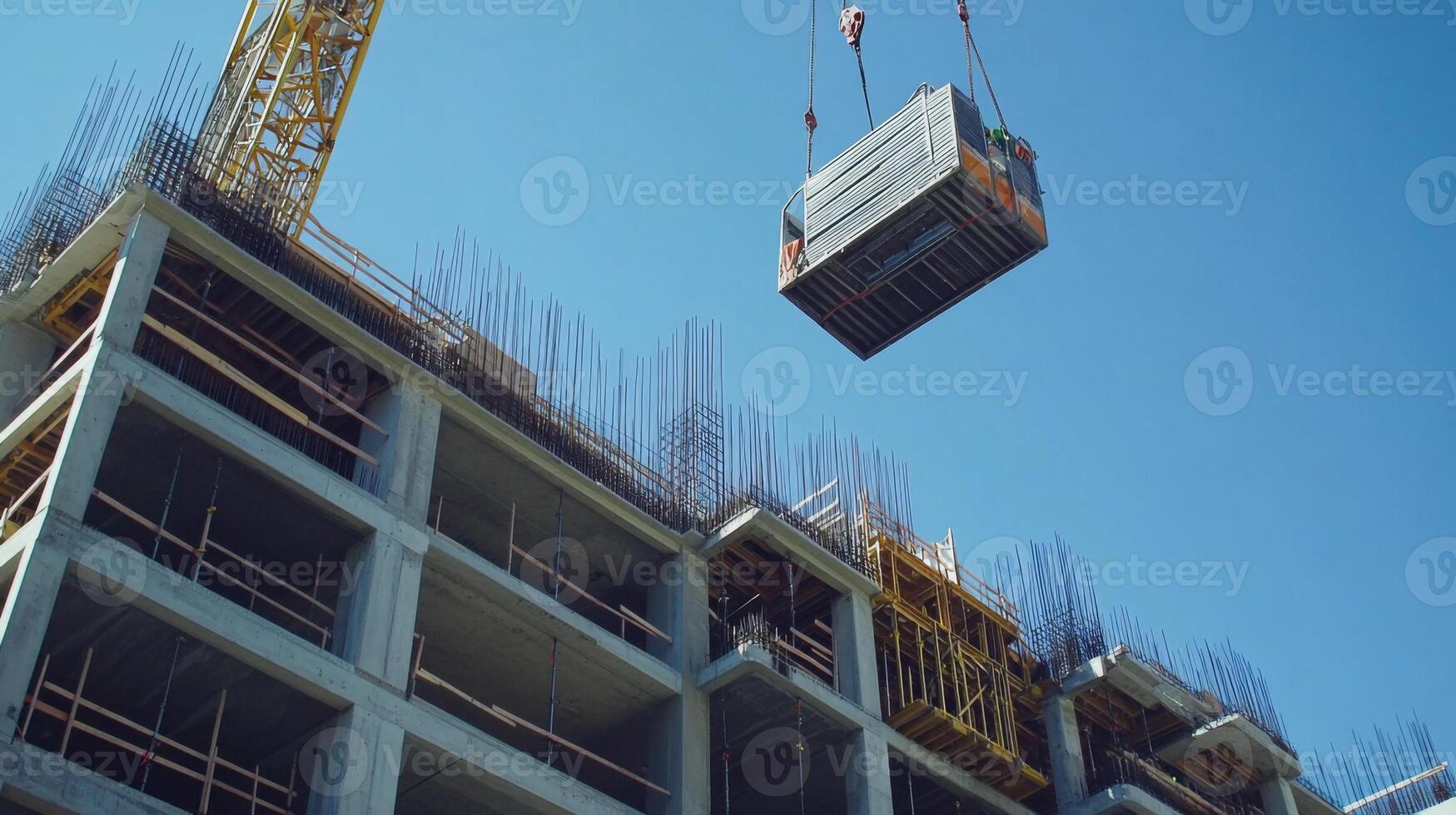 Crane Lifting Concrete Formwork During Construction of a Multi-Story Building photo