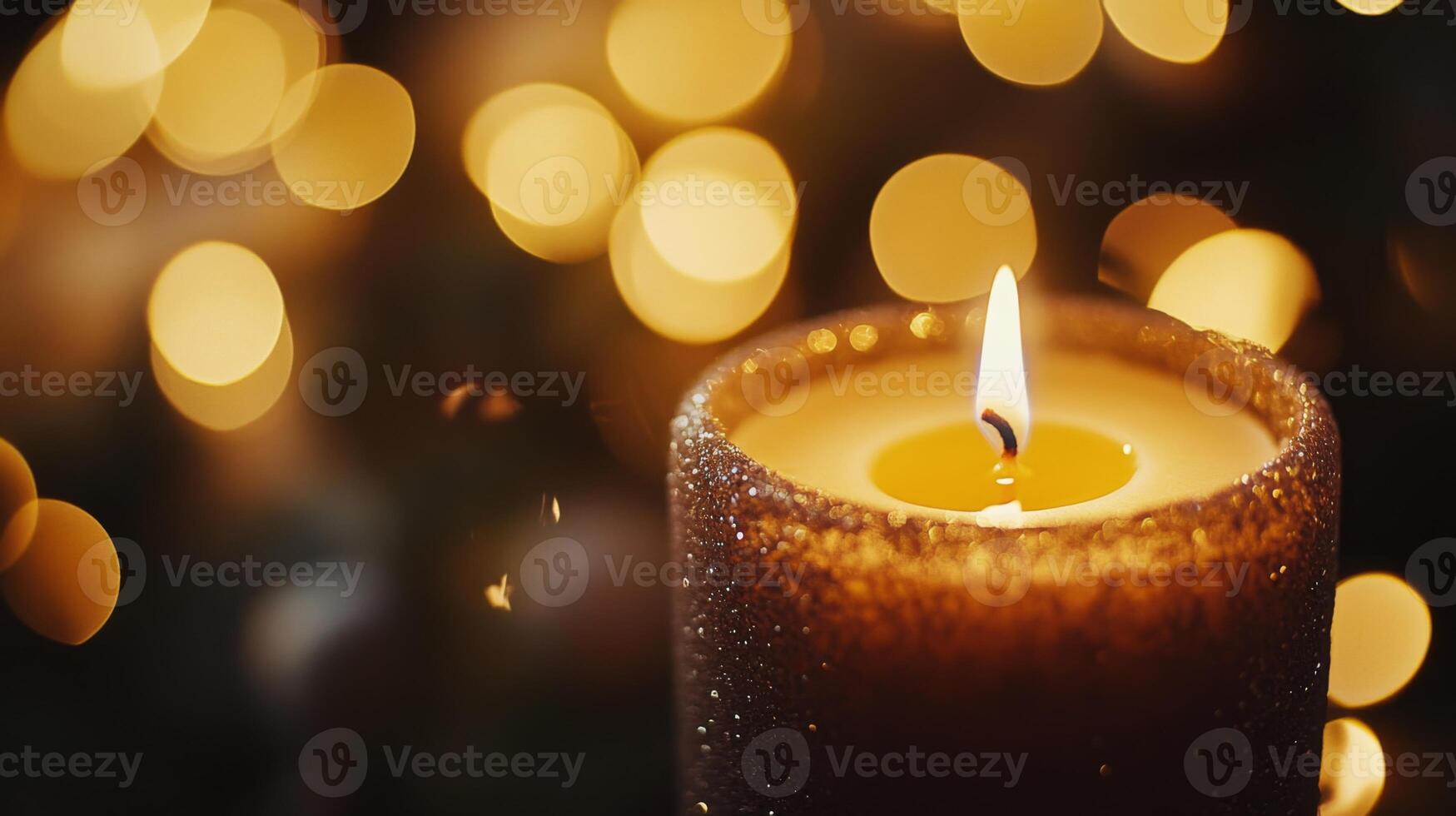A Single Burning Candle With a Glittery Surface and Bokeh Lights in the Background photo