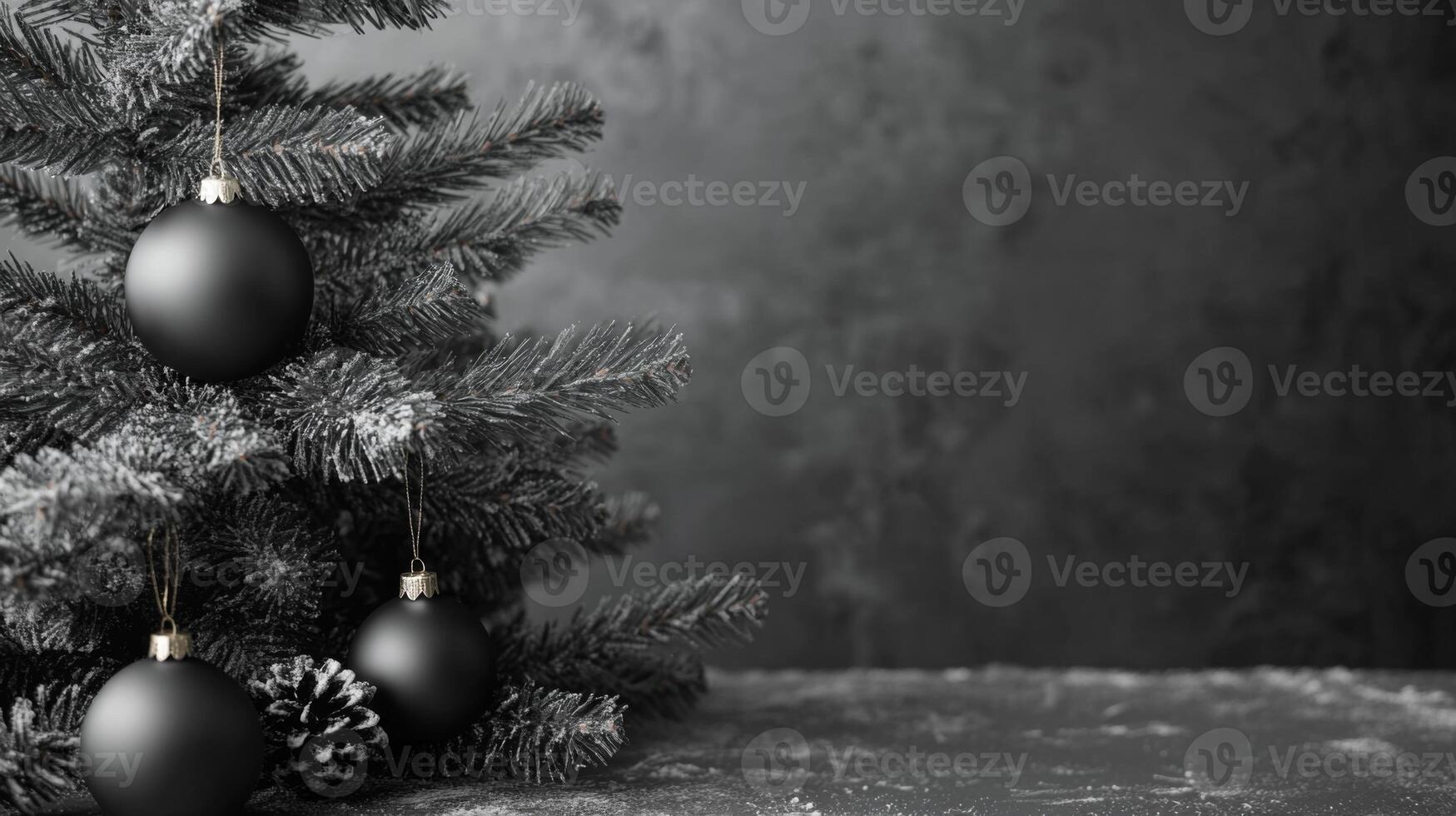 Black Christmas Ornaments on a Snowy Fir Tree Branch photo