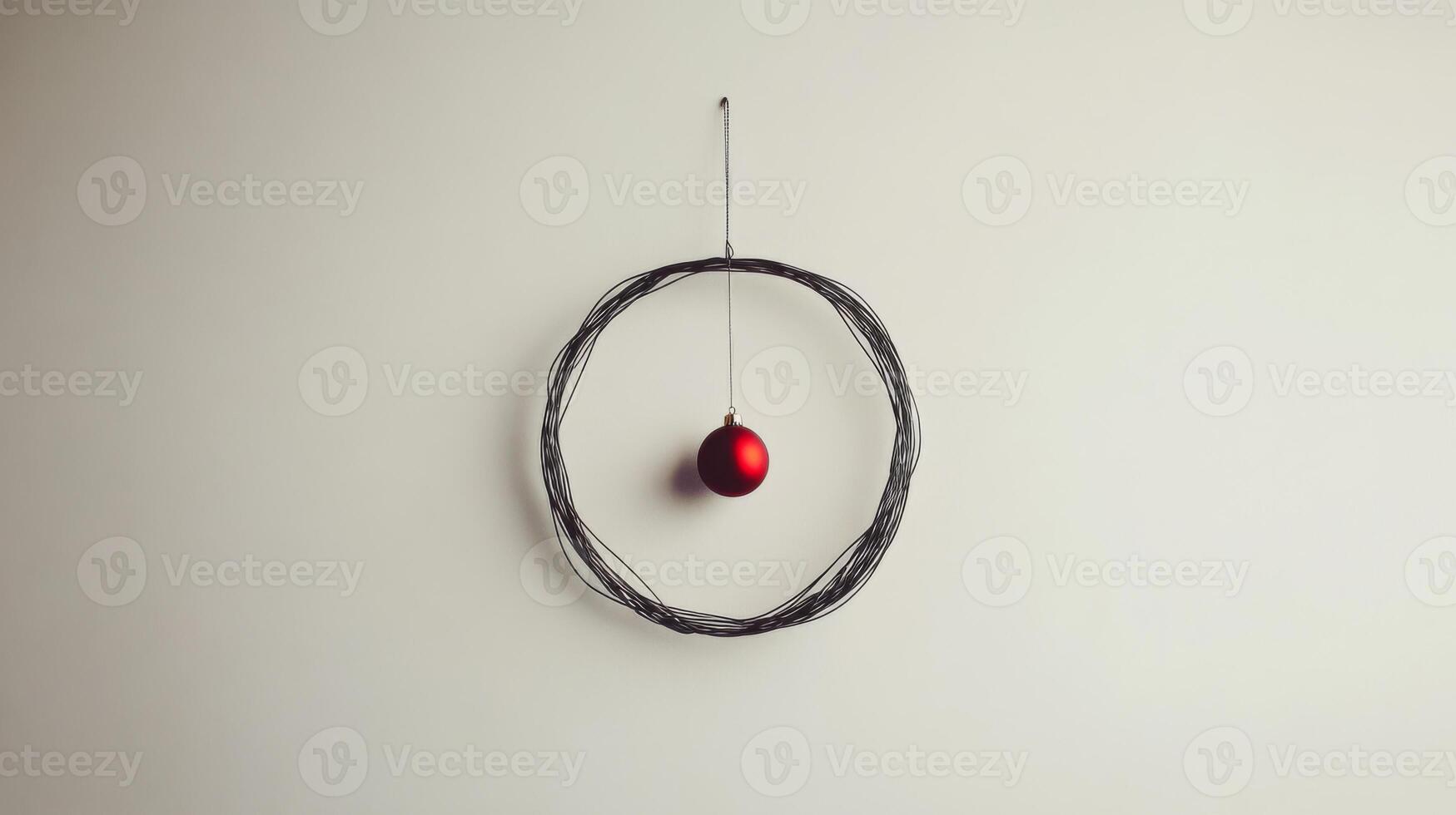 A Single Red Ornament Hanging Within a Wire Wreath photo