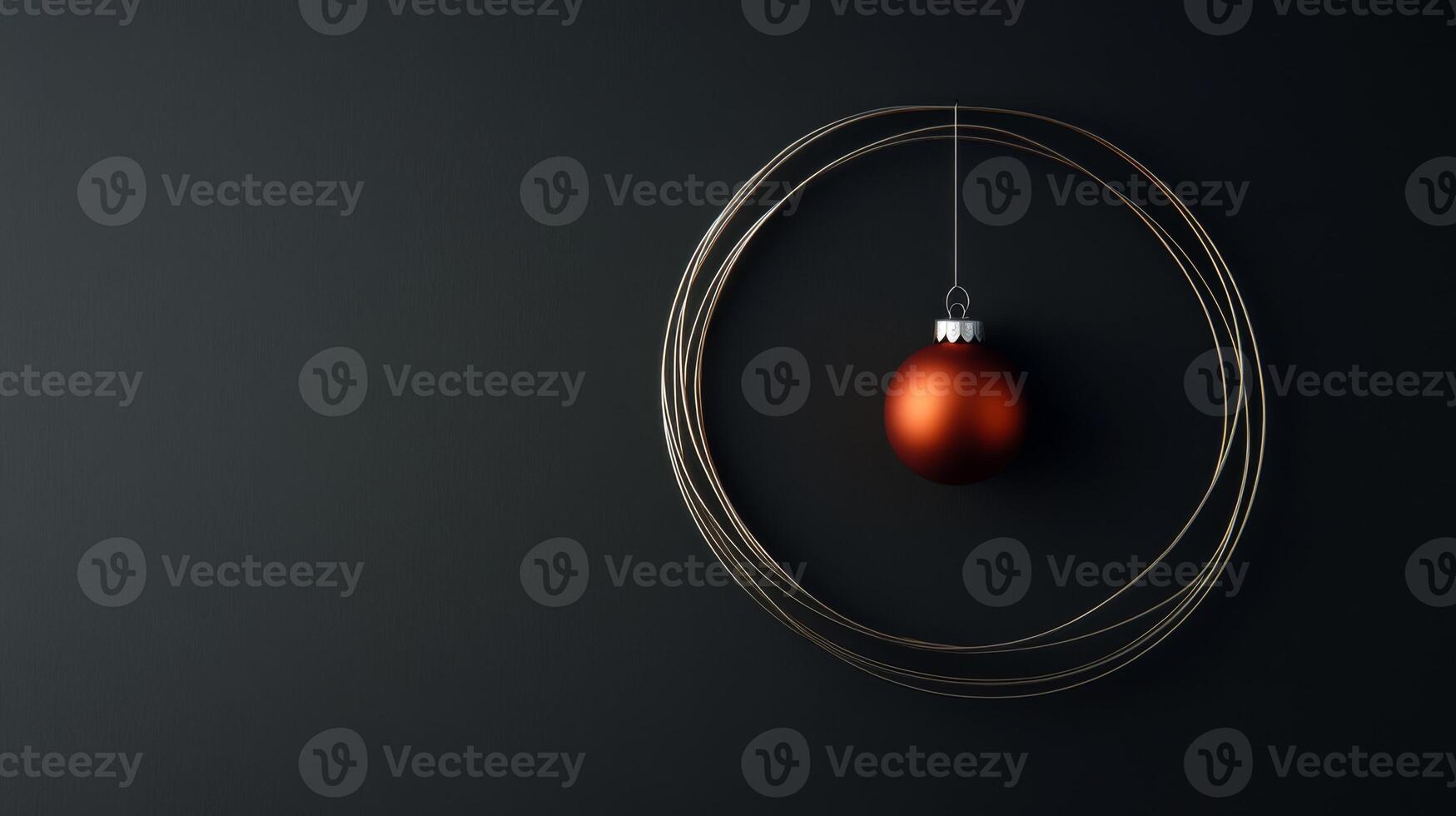 An Orange Christmas Ornament Hanging in a Gold Circle on a Black Background photo