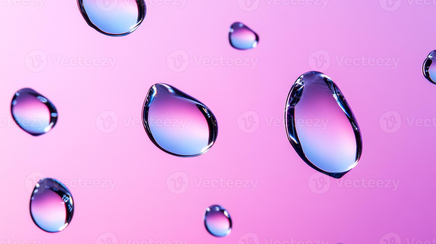 Drops of water on glass creating abstract shapes with a gradient pink and purple background photo