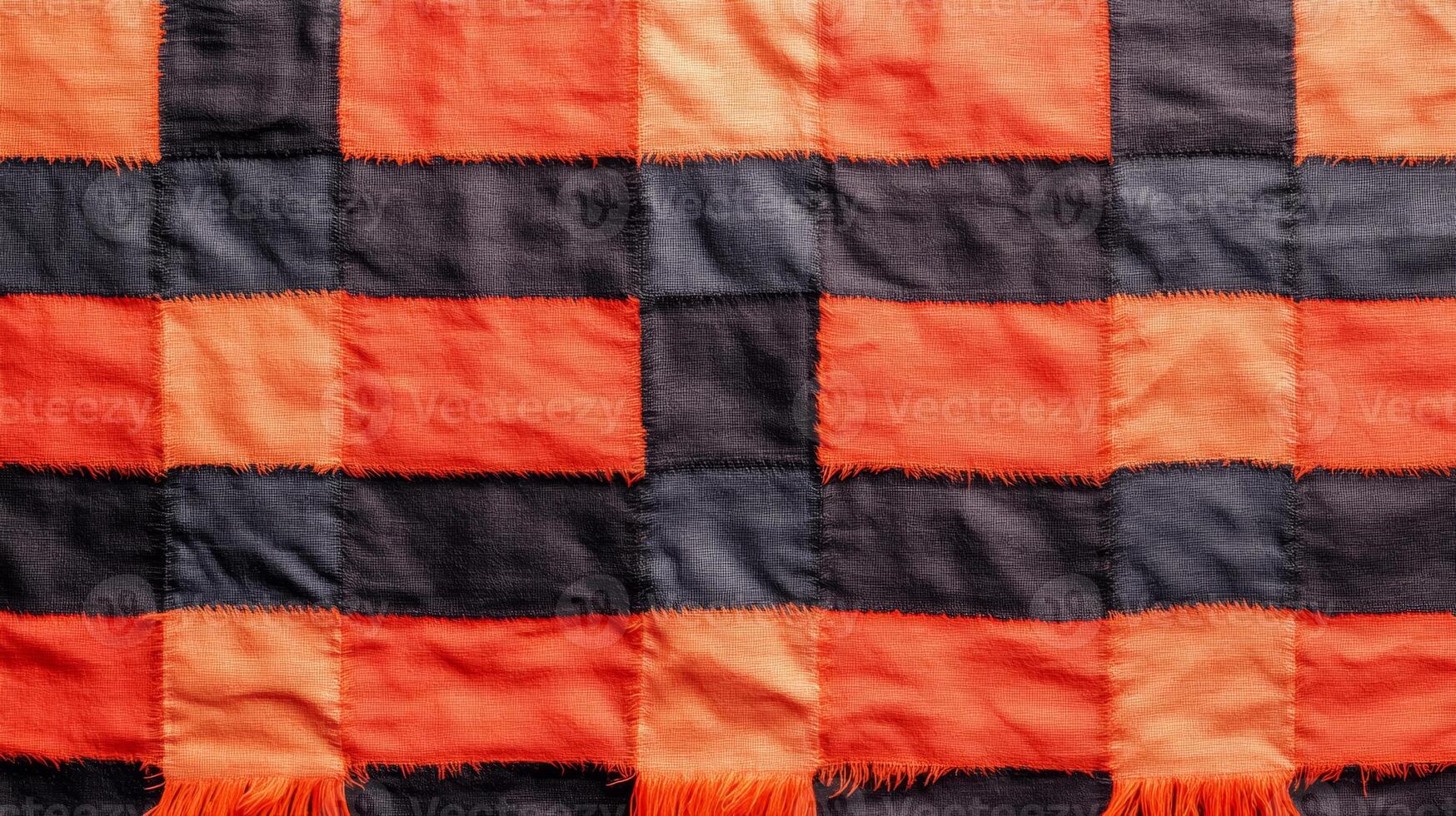 A close up of a blanket with orange and black squares photo