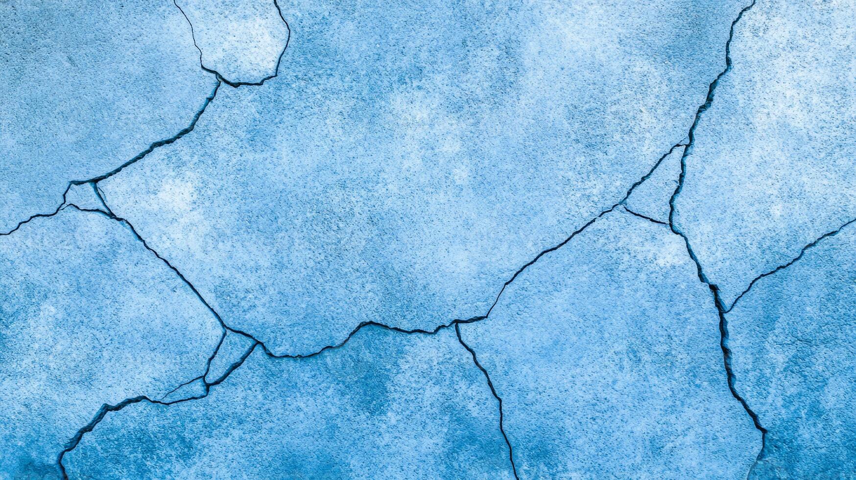 Rough concrete wall texture in vibrant icy blue and silver tones capturing the cool festive essence of New Year abstract cracks and grain for a wintry atmosphere photo
