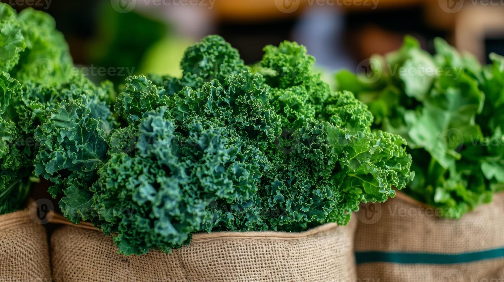 Bunches of green kale with curly leaves on a burlap sack market stall background rustic vibe photo