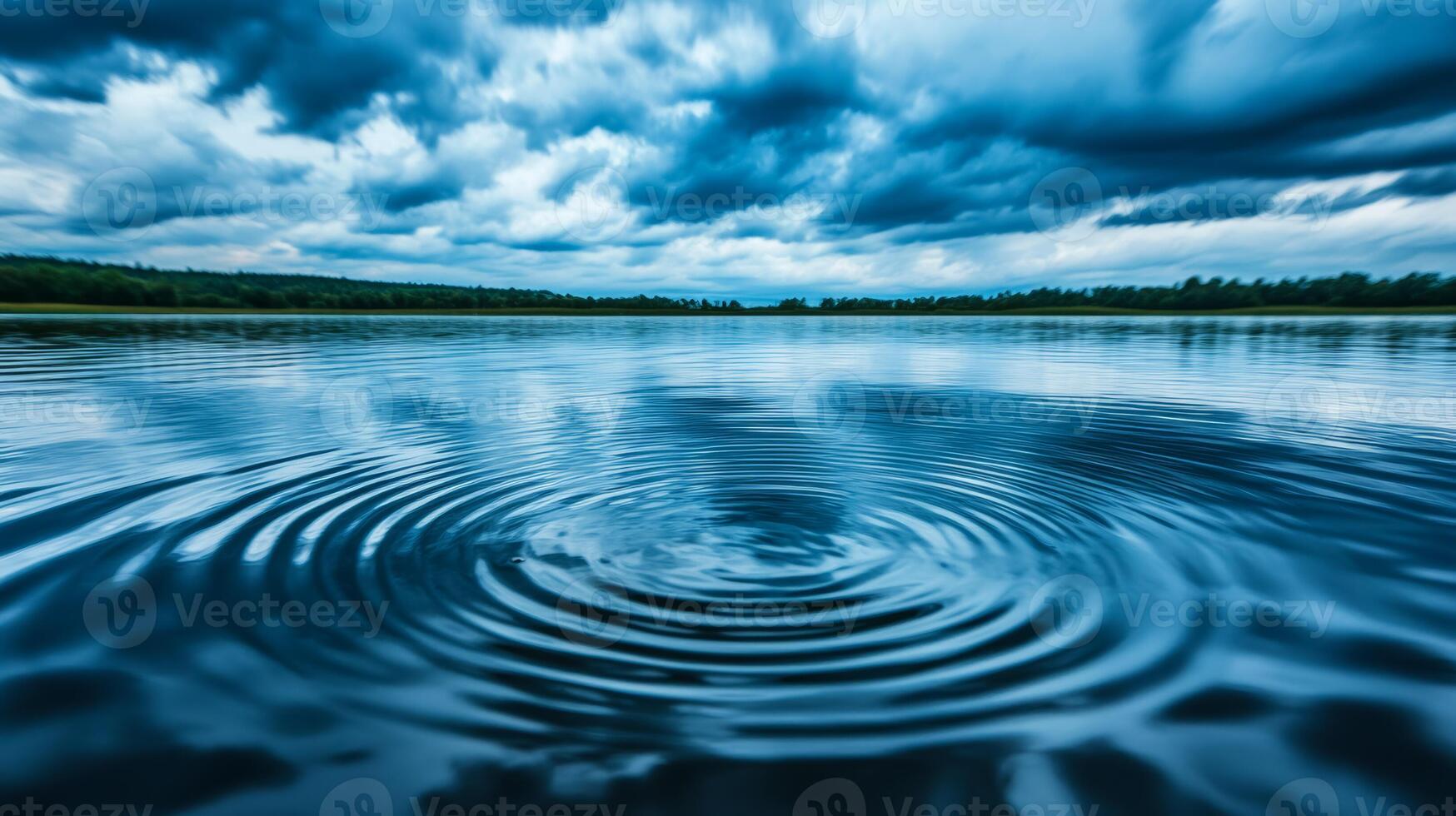 Close up of raindrop ripples on a calm lake surface under a cloudy sky photo