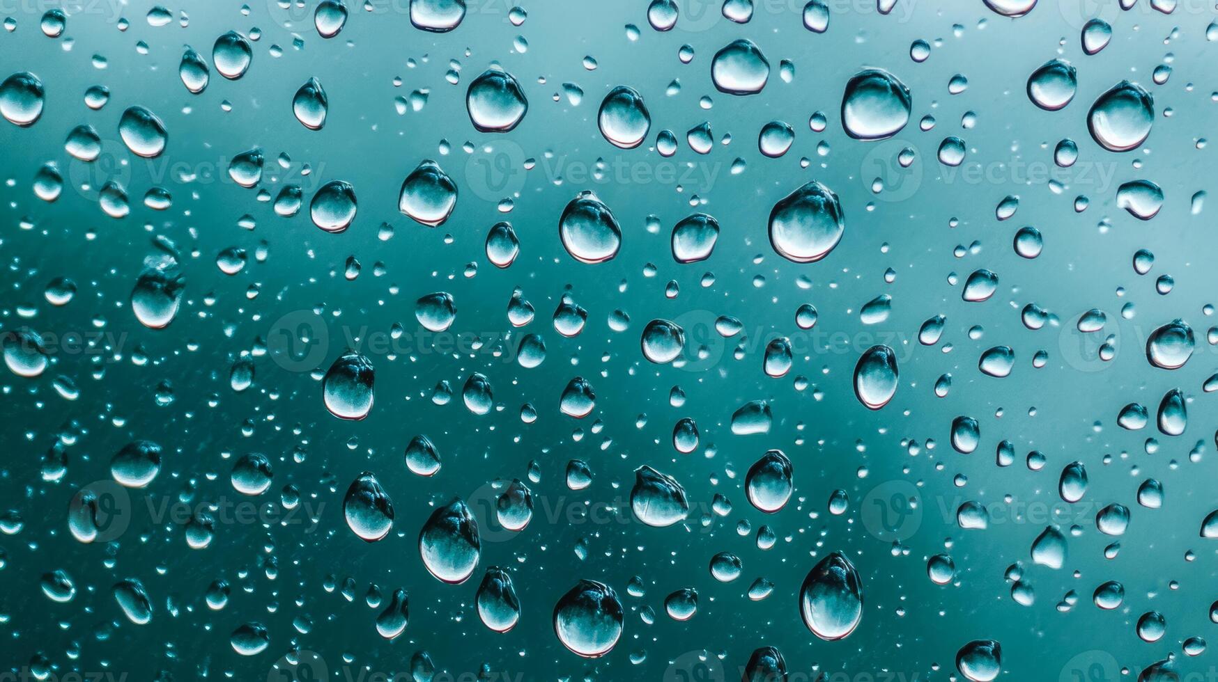 Abstract patterns of water droplets on glass with soft blue and green background tones photo