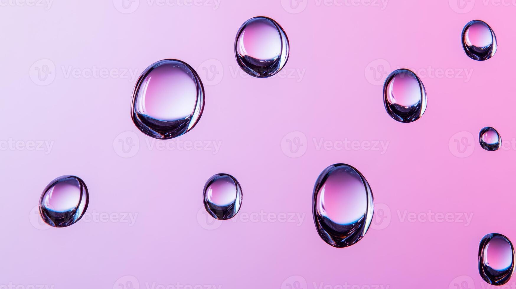 Drops of water on glass creating abstract shapes with a gradient pink and purple background photo