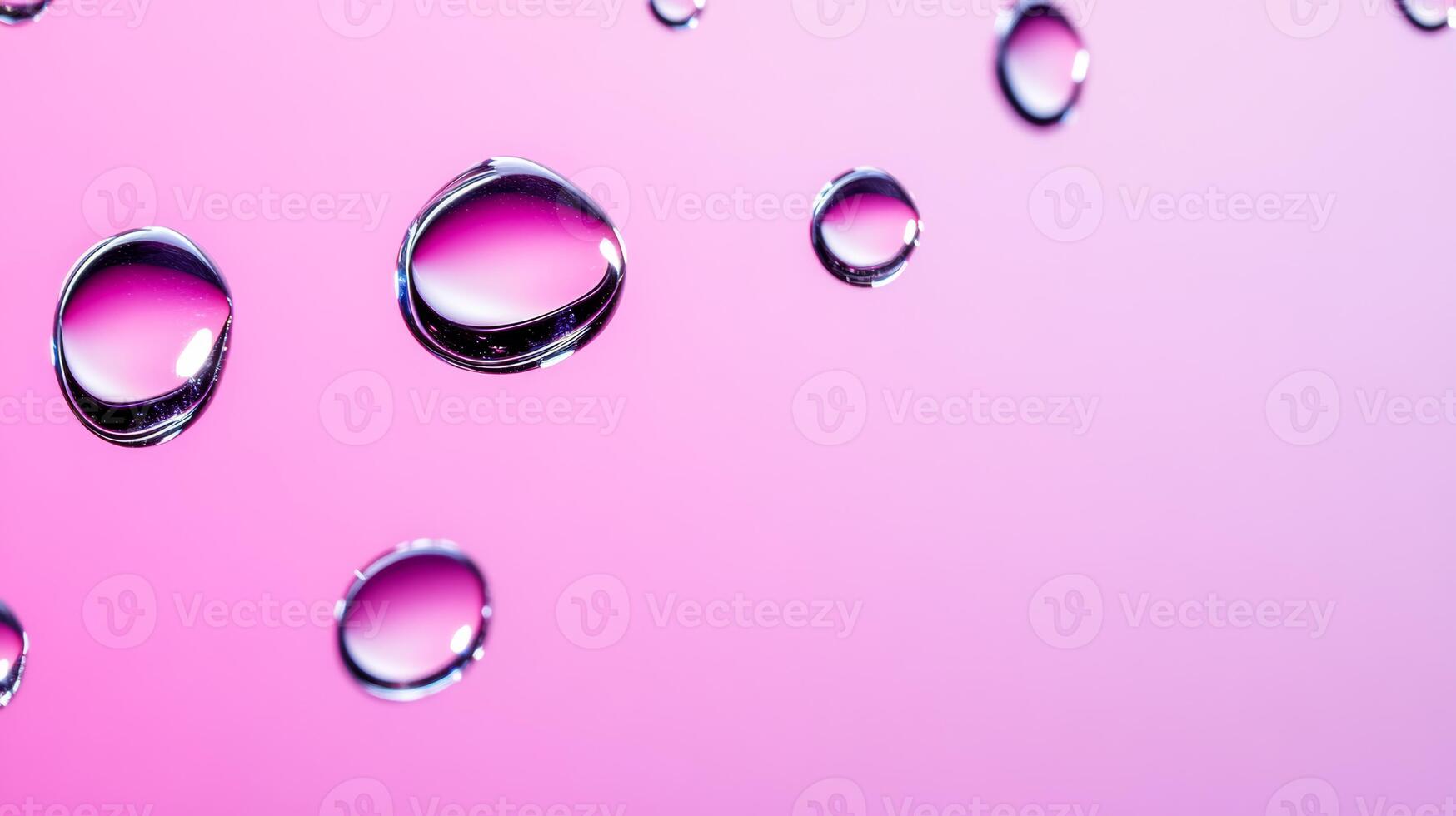 Drops of water on glass creating abstract shapes with a gradient pink and purple background photo