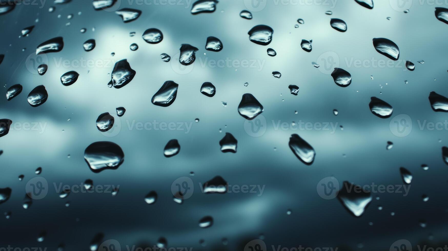 Heavy raindrops on glass with dark storm clouds in the background photo