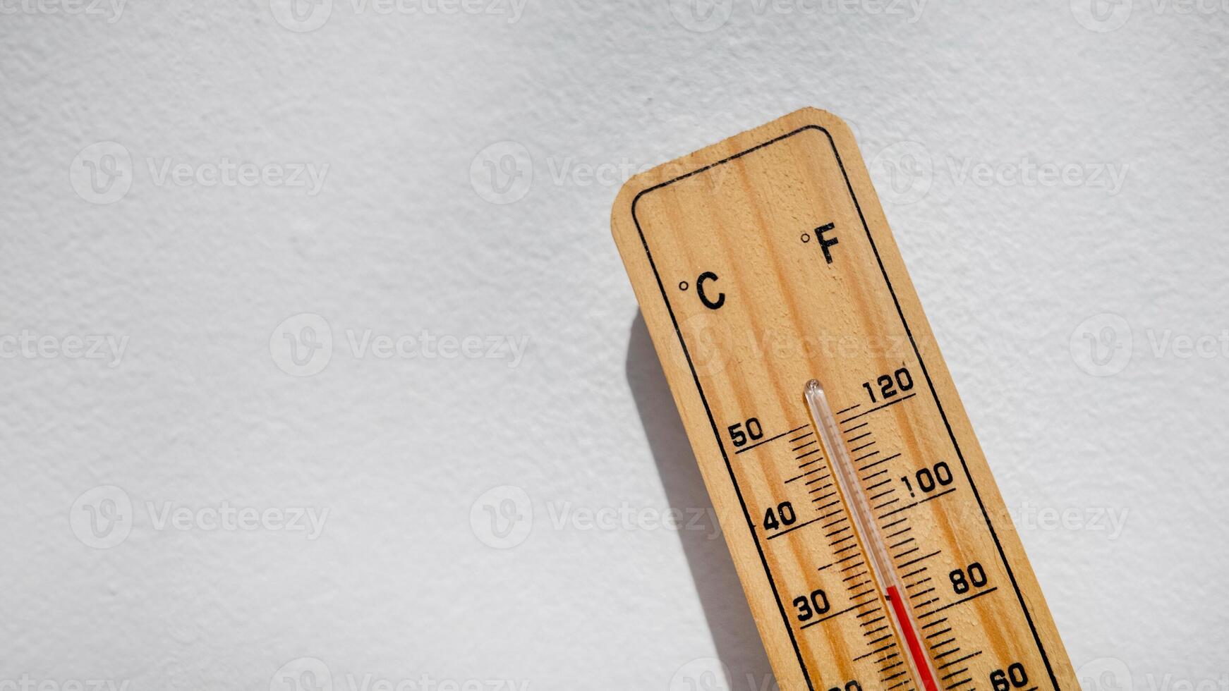 Wooden thermometer showing high temperature, symbolizing heatwaves, climate change, and summer weather issues photo