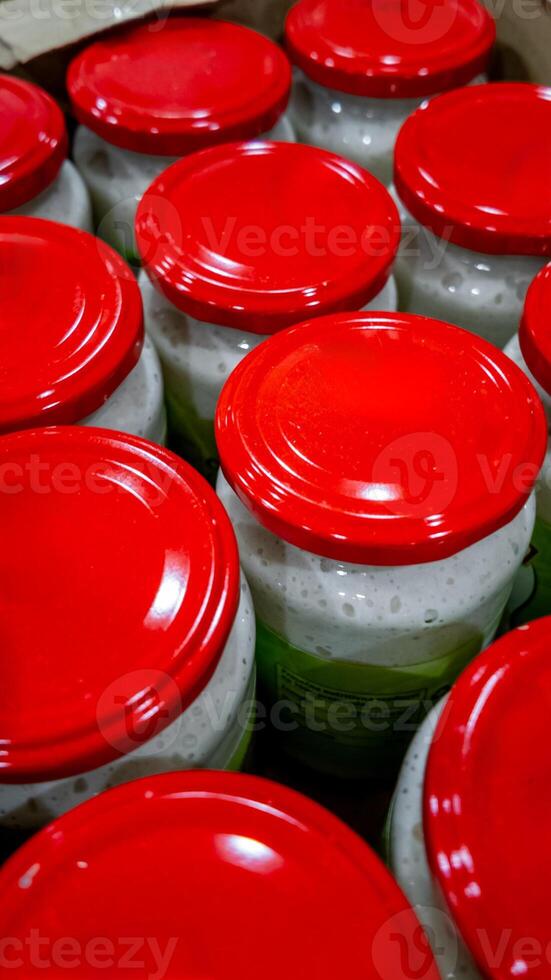 Rows of jars with red lids suggest food preservation concept ideal for stockpiling and emergency preparedness photo