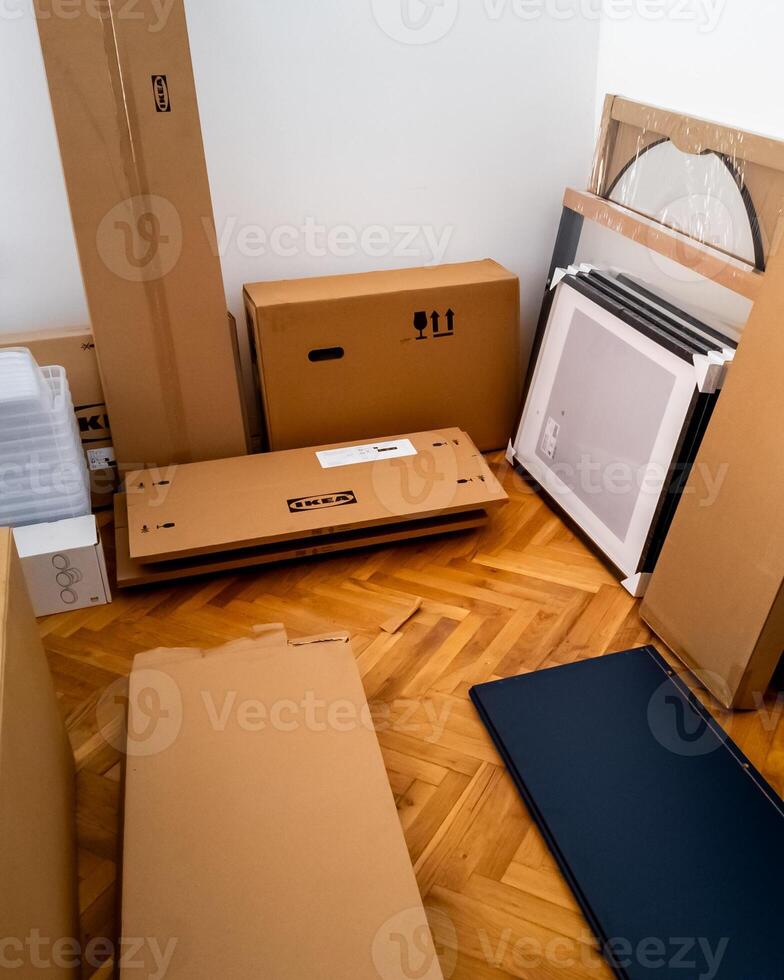Various flatpack furniture boxes ready for assembly in a home, representing DIY challenges and the concept of home improvement photo