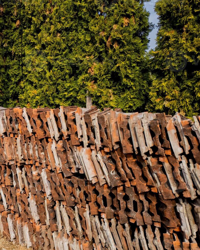 Stacked tiles against lush greenery, representing sustainable building materials and eco friendly construction concepts photo