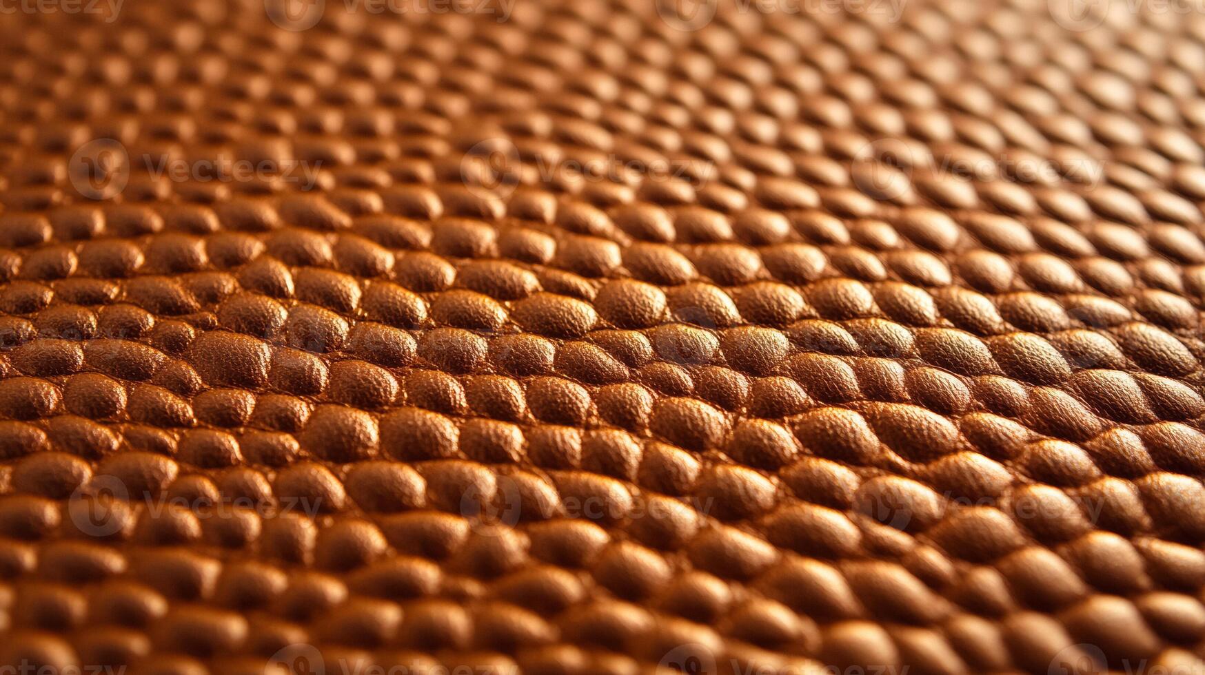 Closeup of metallic copper leather with a rich textured surface and shimmering highlights showing warmth and luxury photo