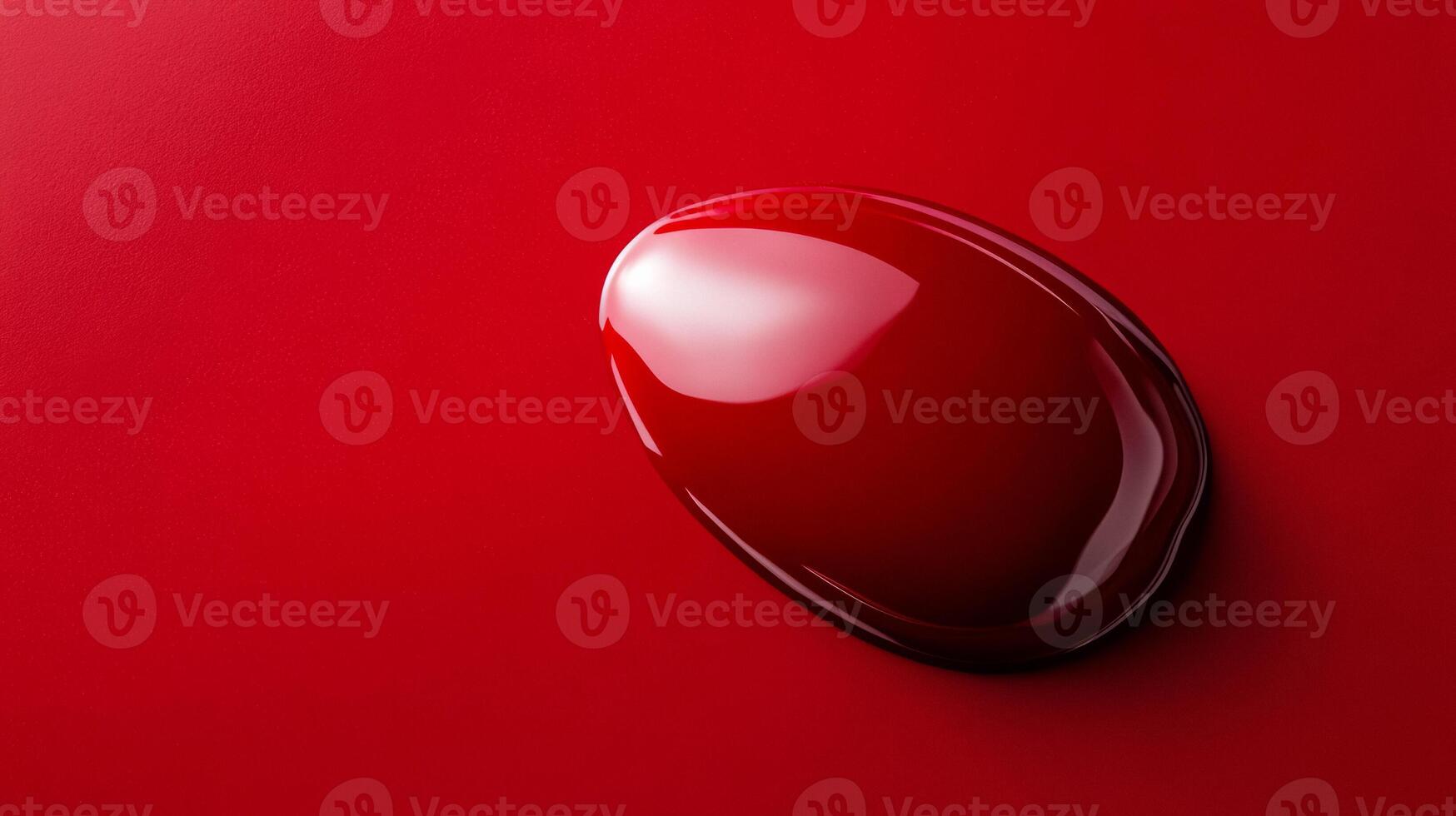 Closeup of ruby red nail polish drop with thick texture glossy finish reflecting light against a smooth background photo