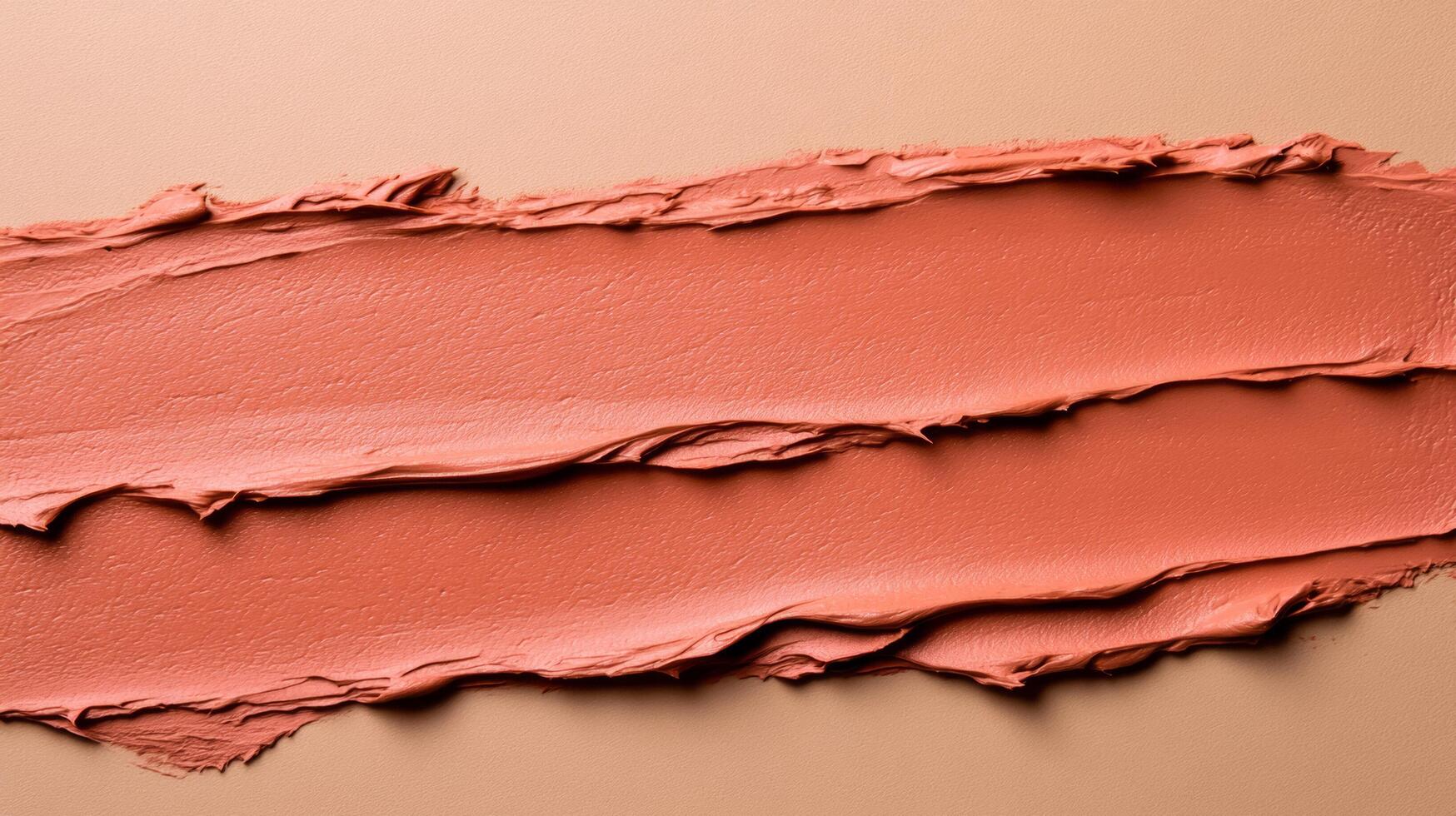 Closeup of terracotta clay mask smeared in rough organic lines on a smooth beige background photo