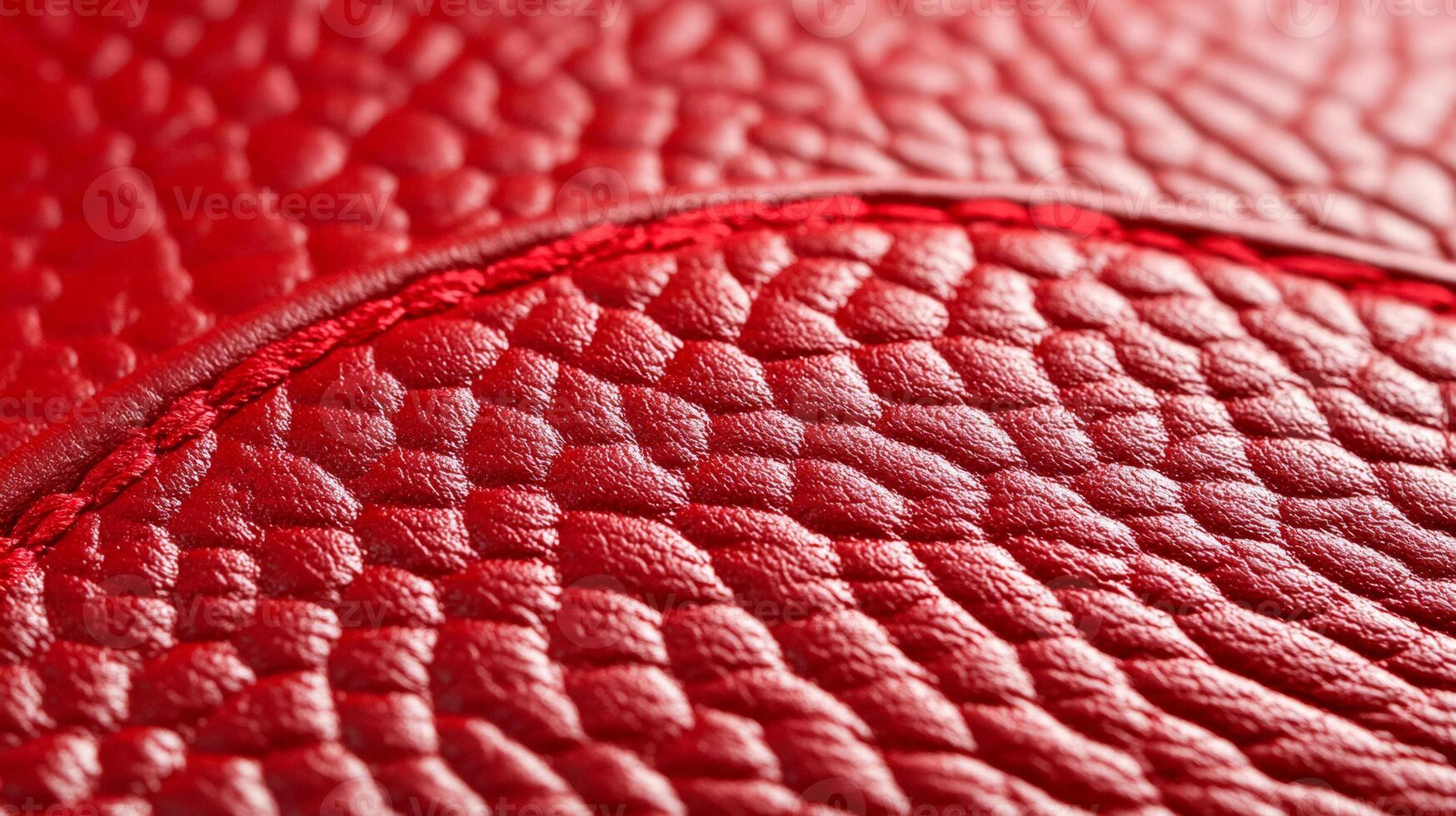 Closeup of textured red leather with a bold vibrant hue and slightly distressed finish capturing rugged elegance photo
