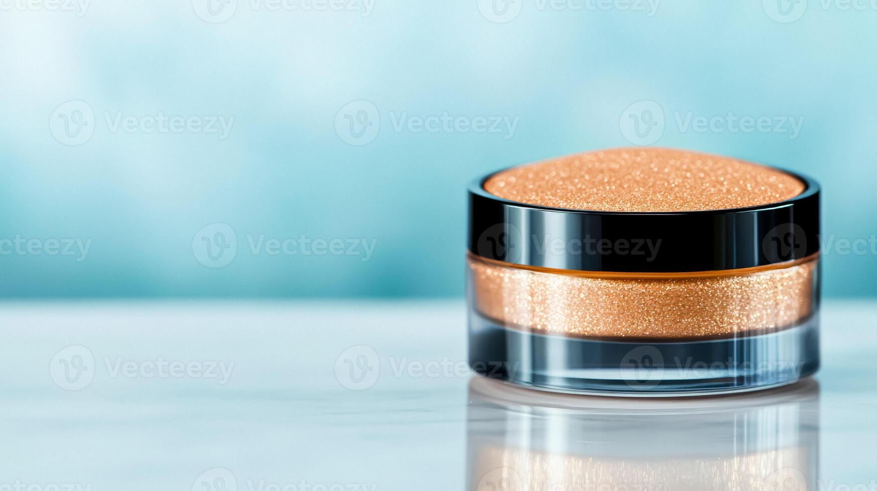 Luxurious rose gold highlighter spread with a soft creamy texture on a reflective glass surface catching light photo