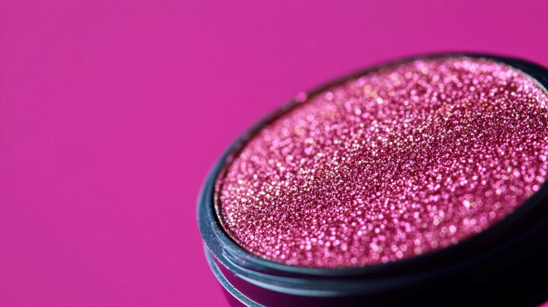 Macro of warm taupe eyeshadow with hints of gold sparkles blending into a deep plum background photo