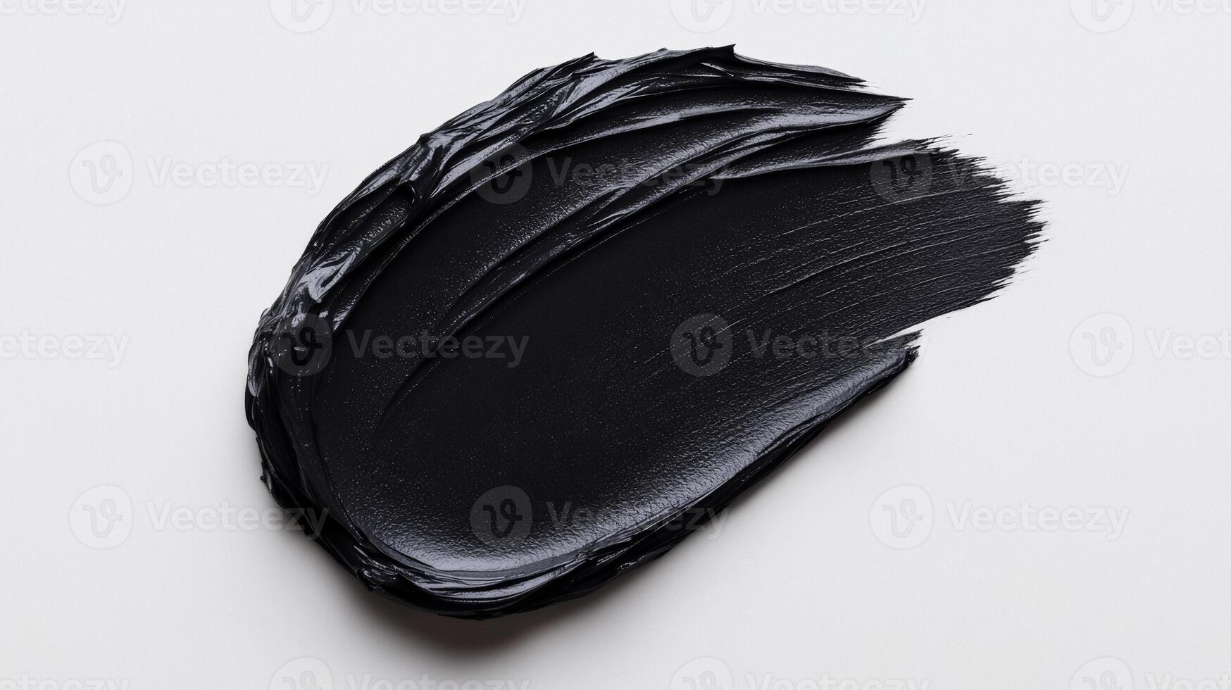 Matte black cosmetic clay mask spread in smooth thick lines on a stark white background with subtle texture photo