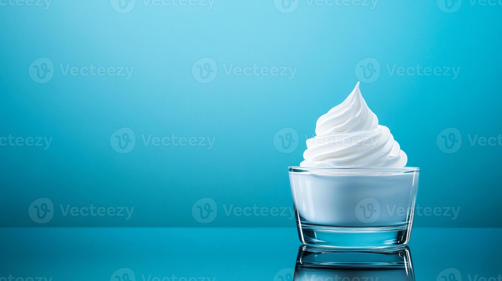 Pearly white moisturizer cream swirl on a smooth glass surface with a faint reflection and subtle iridescence photo