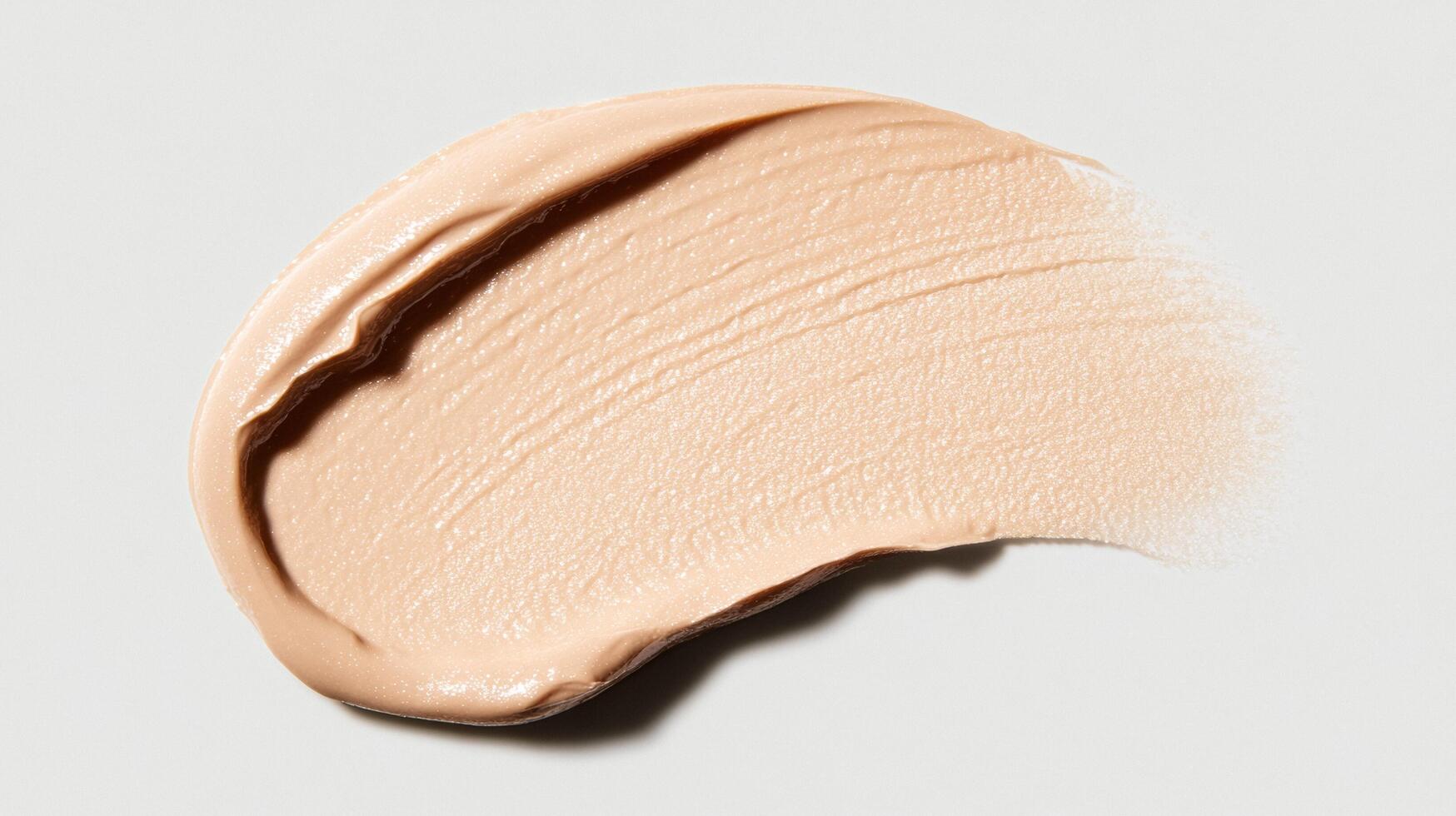 Soft ivory foundation swatch with a pearlescent glow resembling freshly fallen snow on a clear background photo