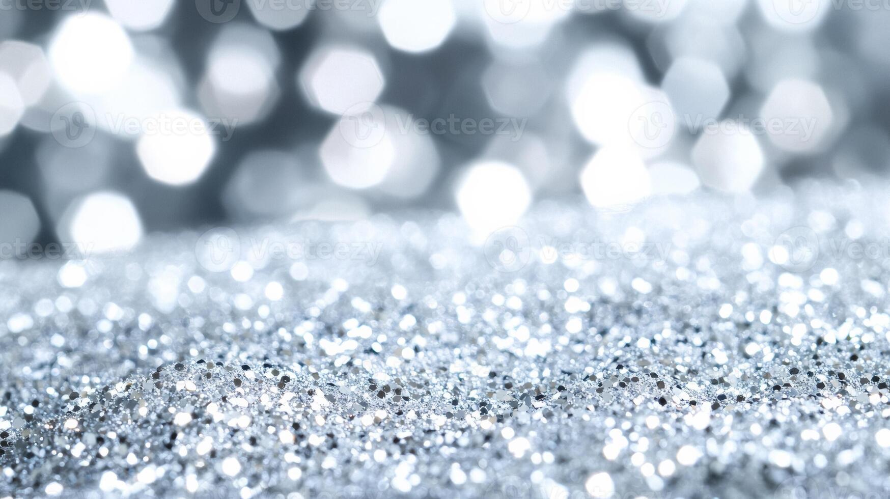 Sparkling white glitter suspended in clear serum resembling fresh snow on a frosty morning against a silver background photo