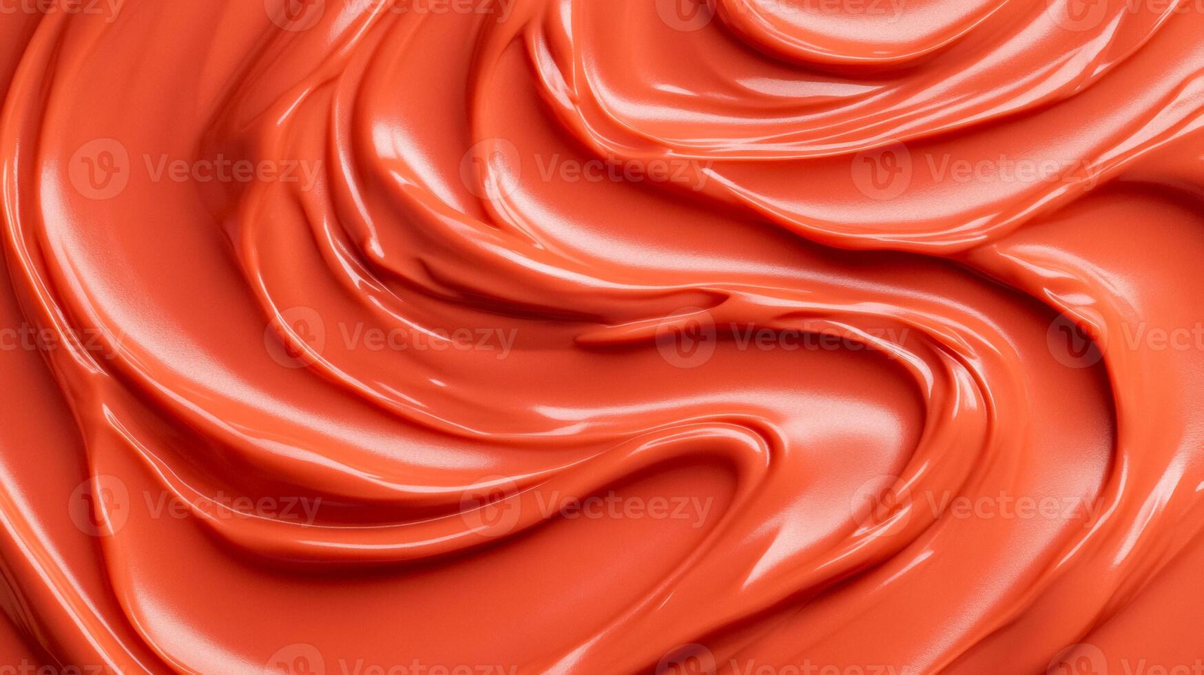 Swirls of rich coppery red liquid lipstick creating an abstract pattern on a soft muted orange background photo