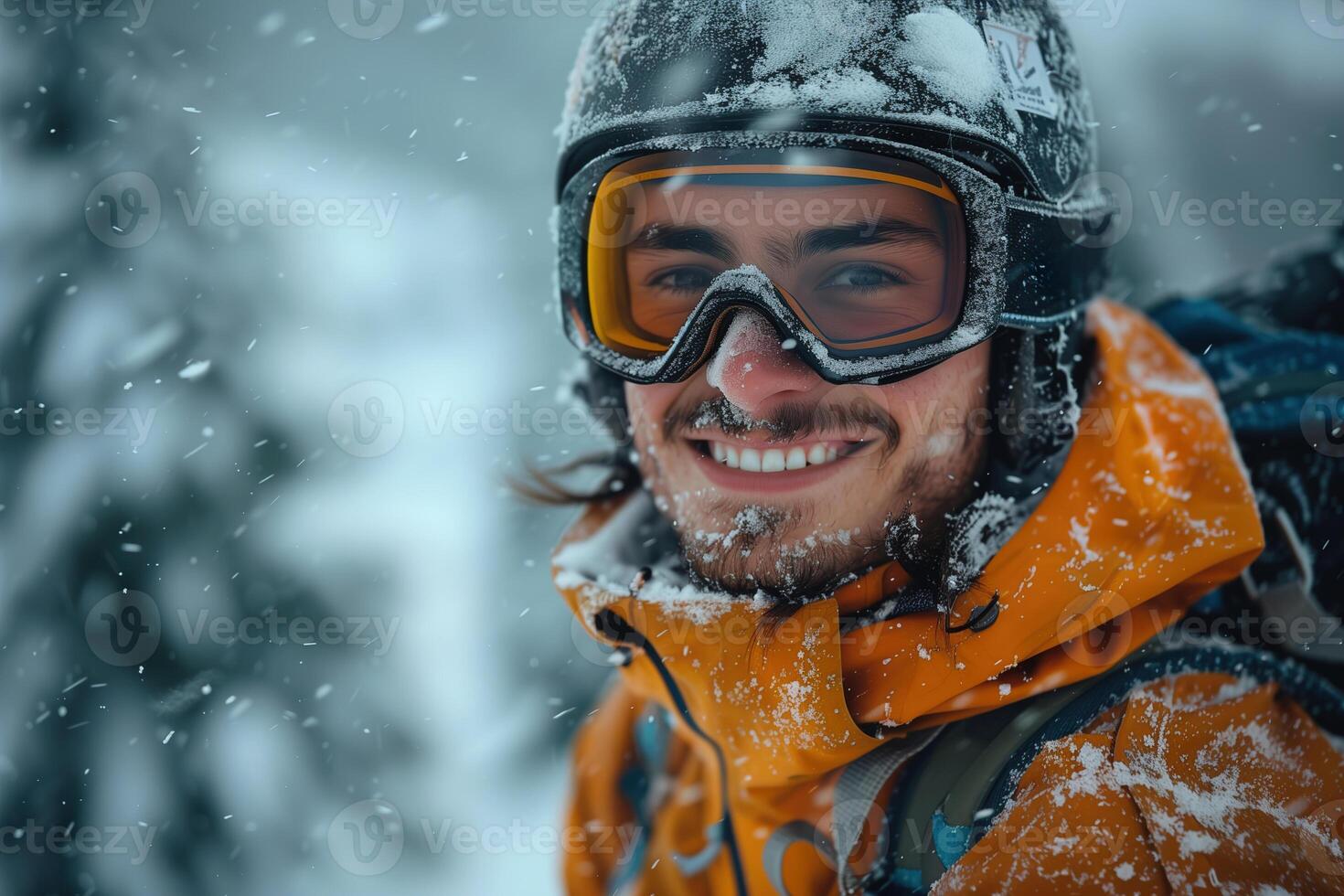 A man in a snow suit smiling in the snow photo