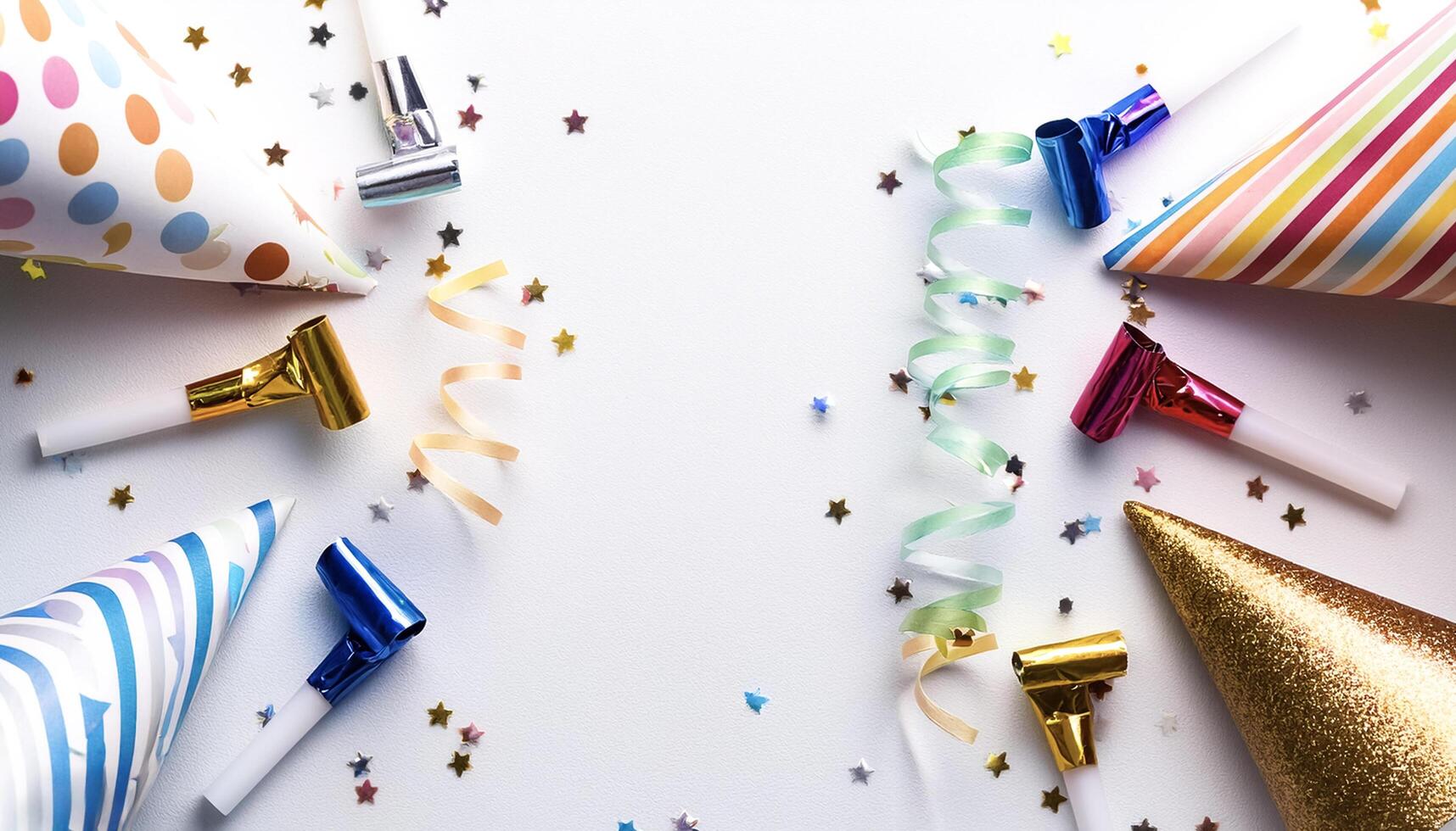Birthday party caps, blowers and candles on white background photo