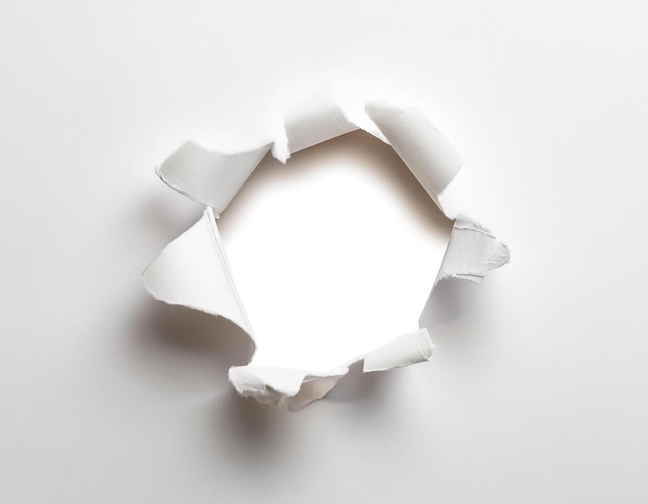 a white paper hole torn photo