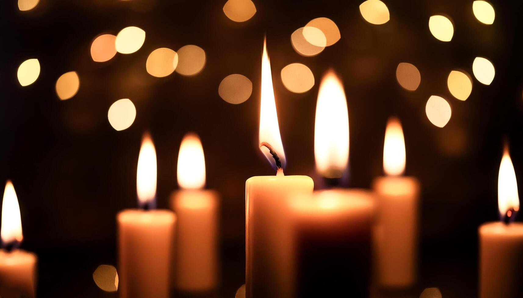 burning candles in the dark against the background of blurry lights photo