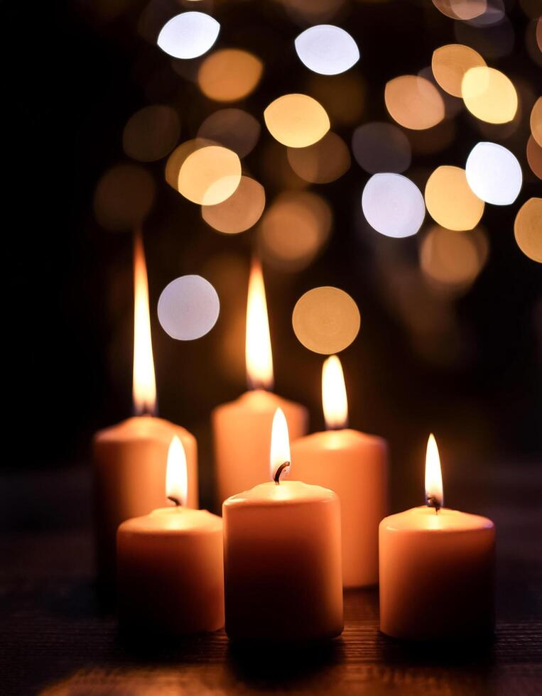burning candles in the dark against the background of blurry lights photo