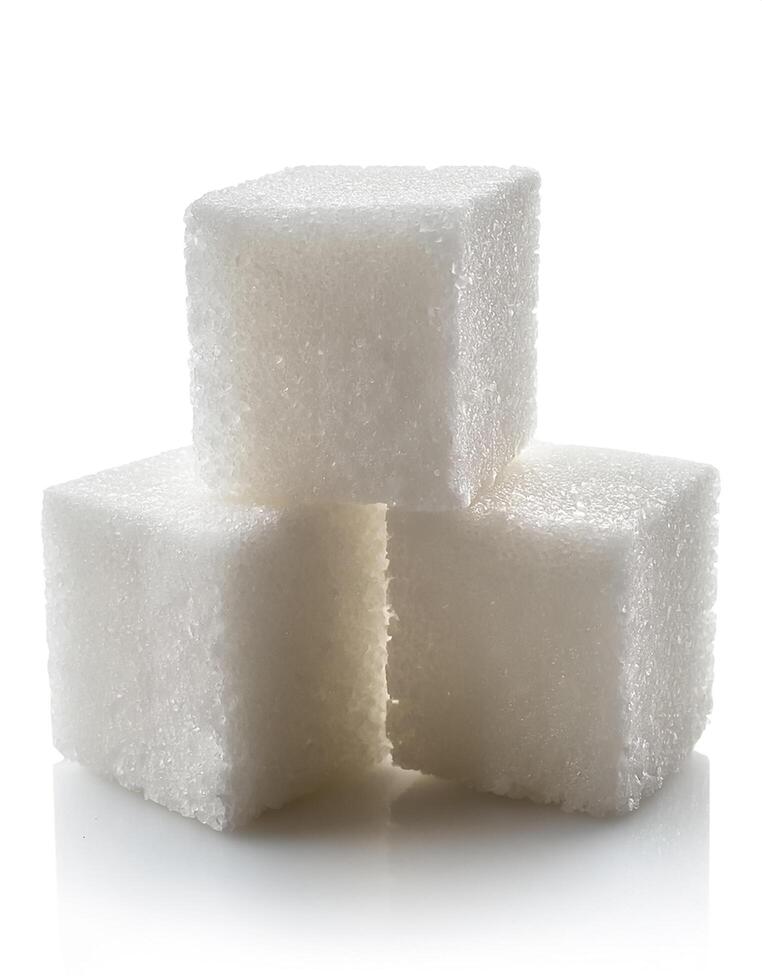 Close-up of three white sugar cubes, isolated on white background photo