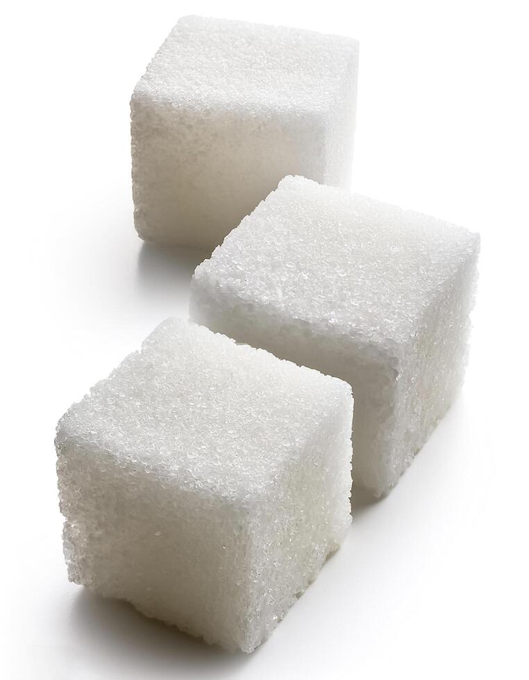 Close-up of three white sugar cubes, isolated on white background photo
