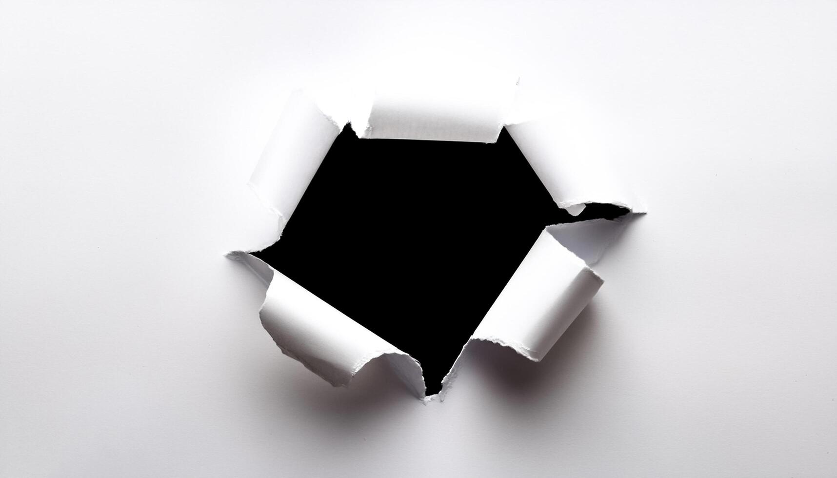 a white paper hole torn photo