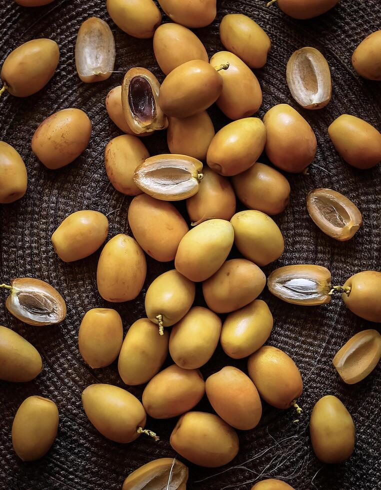 Overhead view of Fresh, Pile, Ripe and juicy sweet yellow date palm. Halves food summer background photo