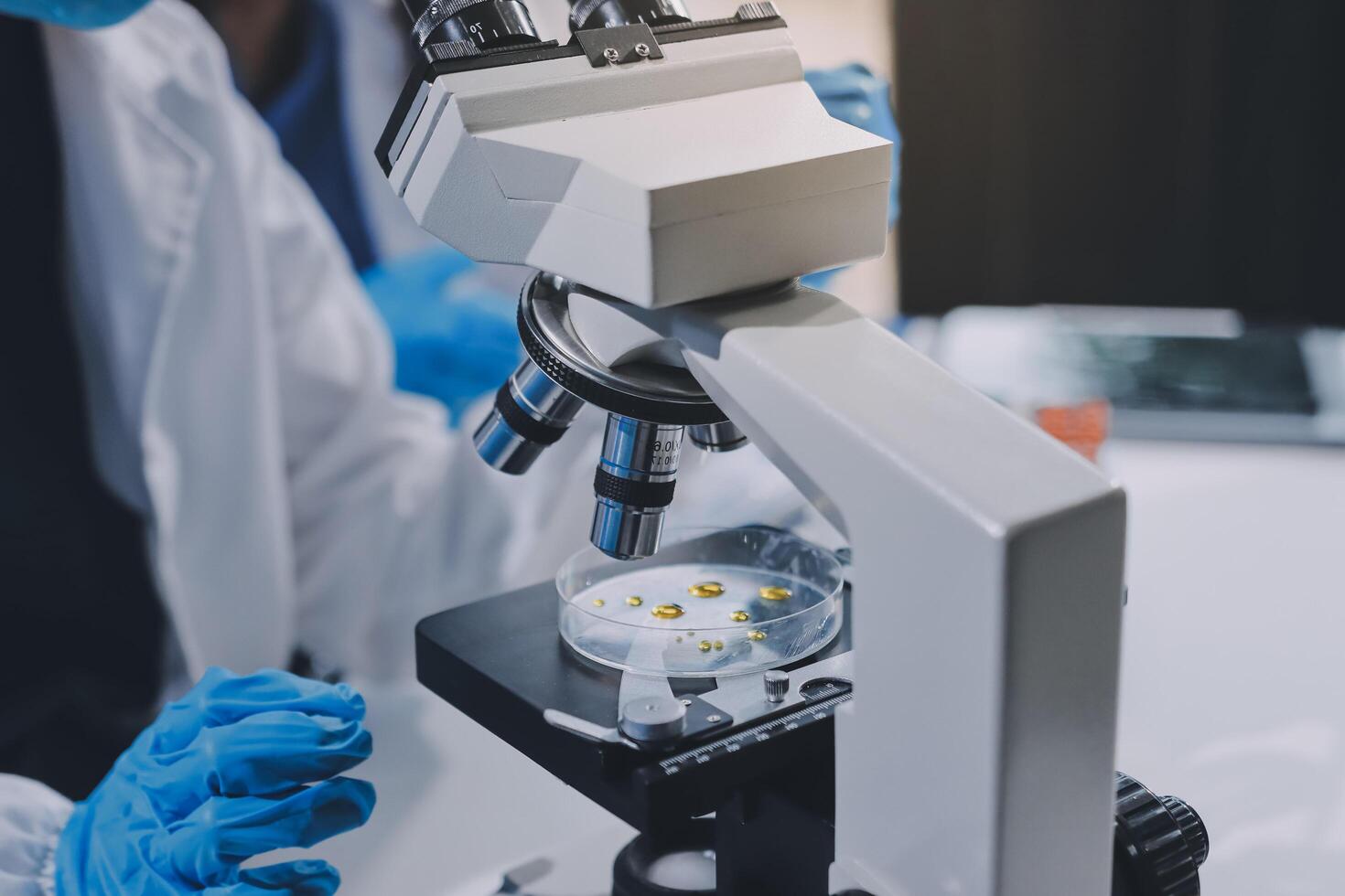 Scientist using microscope in laboratory. Close-up of a researcher's hands adjusting a modern microscope in a lab setting. Science concept photo