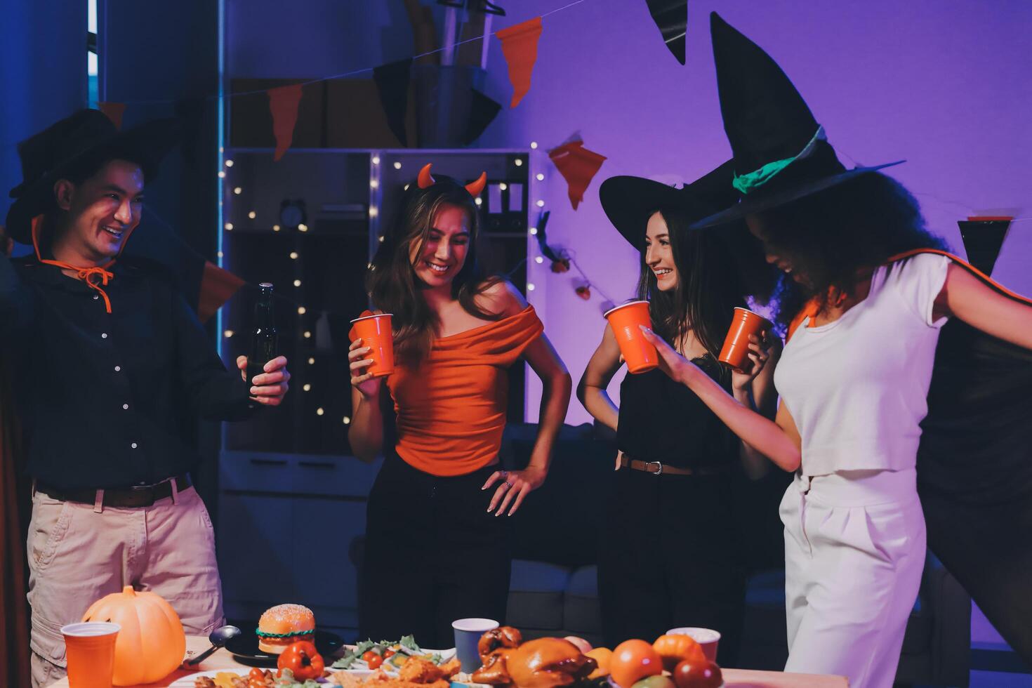 Joyful office Halloween party with coworkers in costumes, celebrating with drinks and laughter, fostering teamwork and festive spirit photo