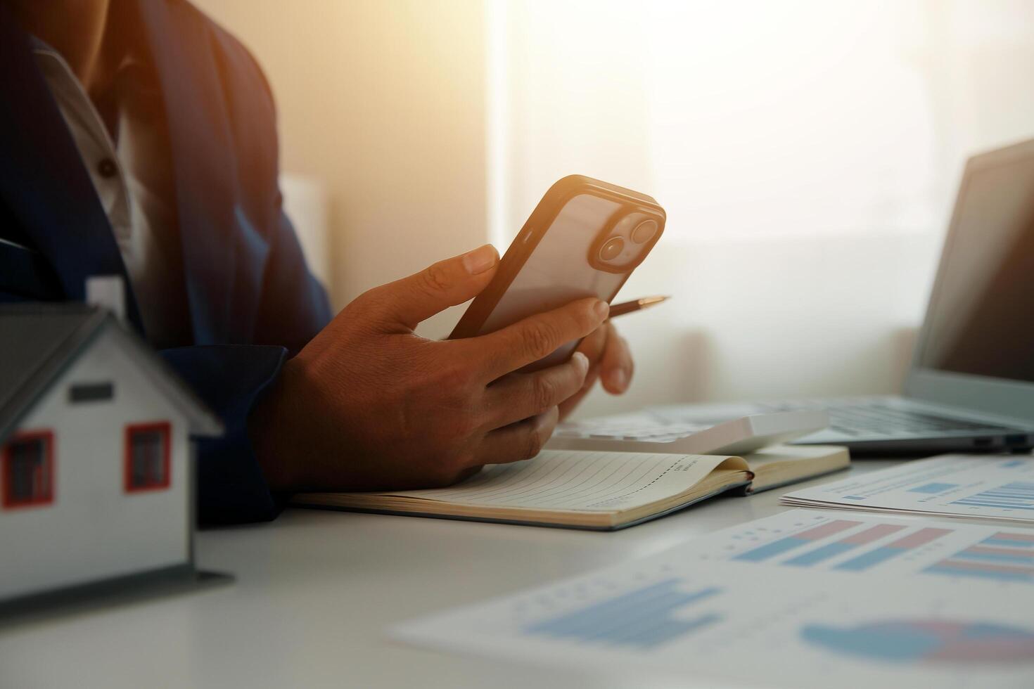 Businessmen holding pens, signing home titles with insurance, care about real estate services and the idea of real estate agents offering interest in installments to their customers. photo