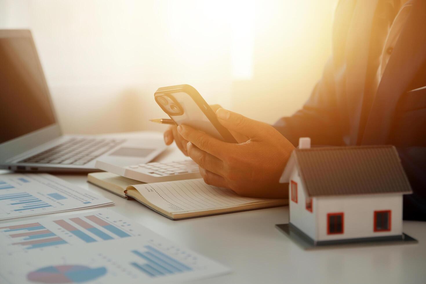 Businessmen holding pens, signing home titles with insurance, care about real estate services and the idea of real estate agents offering interest in installments to their customers. photo